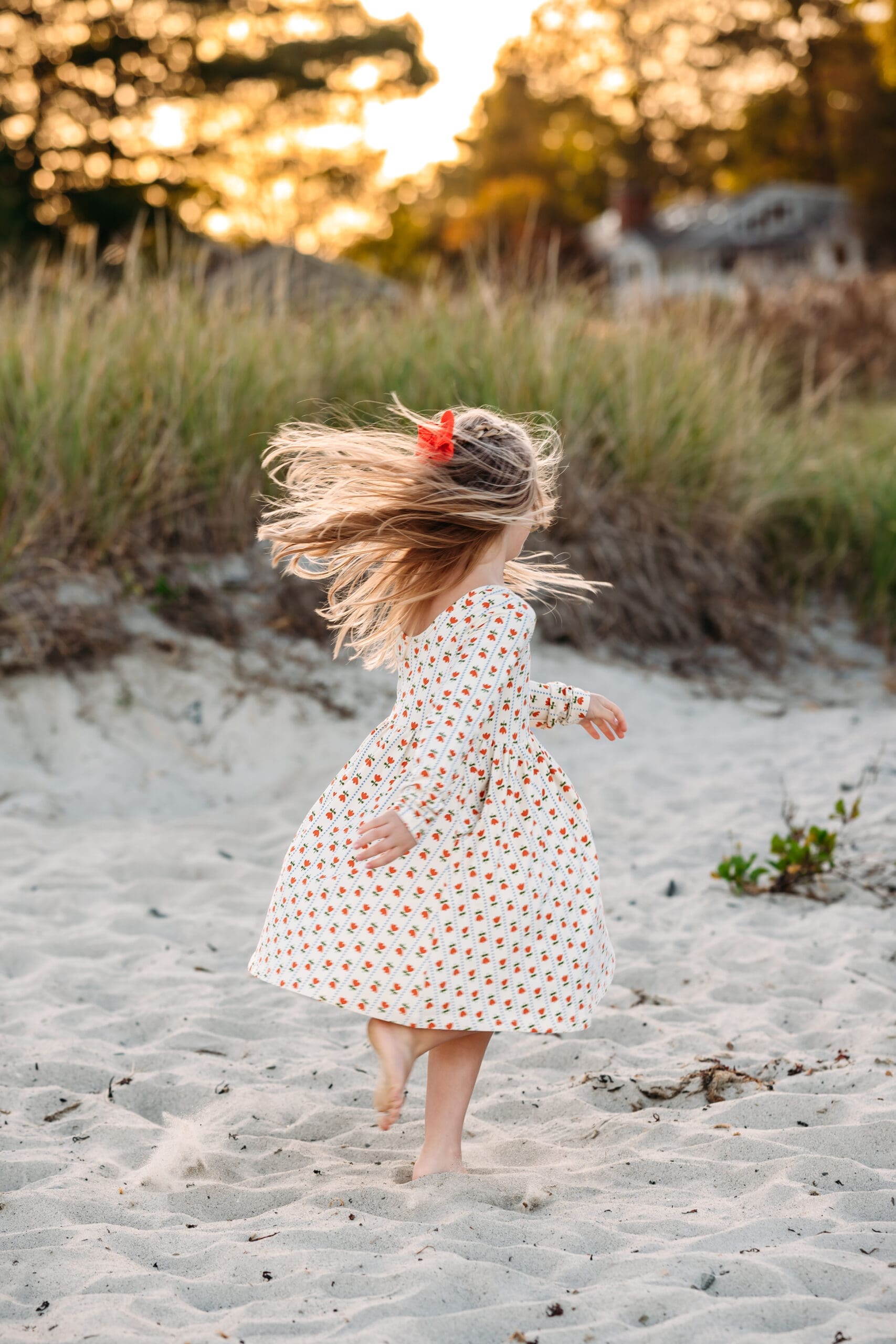 Little Girl twirling at Newcastle Commons beach at golden hour.